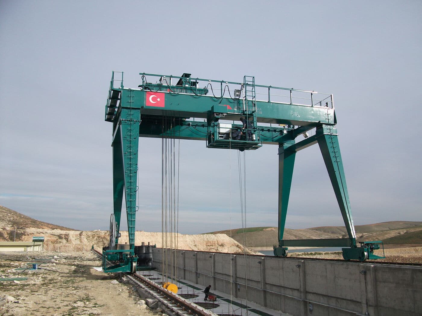 ABRA double girder gantry crane travelling on its ground rail line in an open yard
