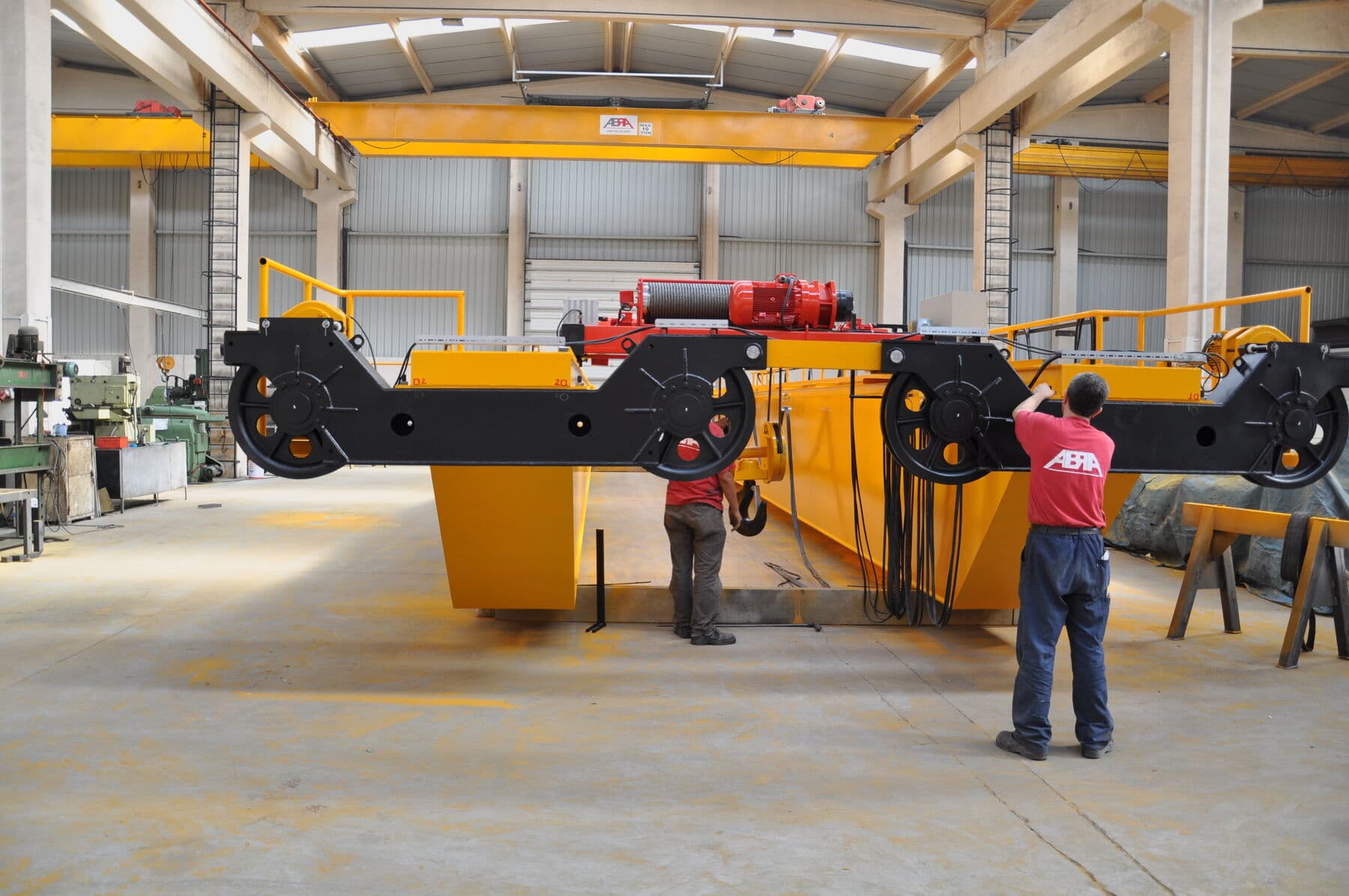 ABRA technicians working on an overhead crane end carriage during a maintenance visit